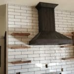 Modern kitchen remodel with stove vent, tile backsplash and shelving for Kitchen Remodel Project in Spearfish, SD with CNT Builders.